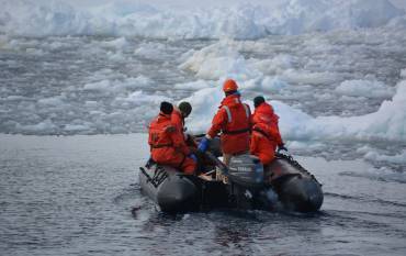 Scientists on a zodiac in West Antarctic Peninsula