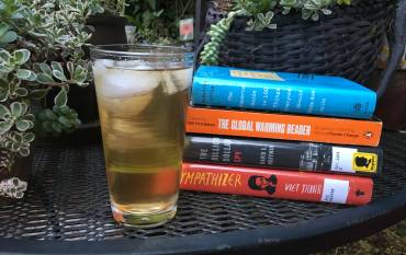 Cold drink next to a stack of books