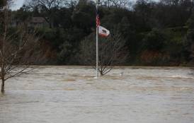 flag pole sticking up above flood waters