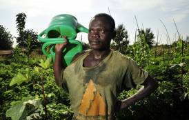 A man holding a watering can in Mozambique