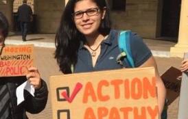 Andrea  Martinez with a taking action sign