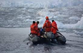 Scientists on a zodiac in West Antarctic Peninsula