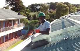 Samuel Adeyemo installing a solar system in Kenya
