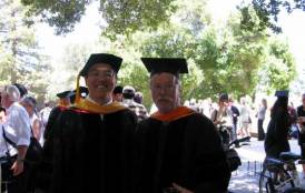 Two men in graduation garbs posing for a picture 