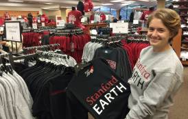 Student holding a Stanford Earth t-shirt in the bookstore
