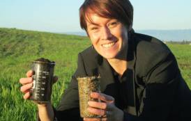 Kate Maher holding containers of soil 