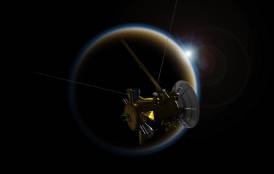 Satellite crossing in front of Saturn's moon, Titan.