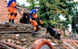 Rescue workers searching through earthquake debris in Nepal