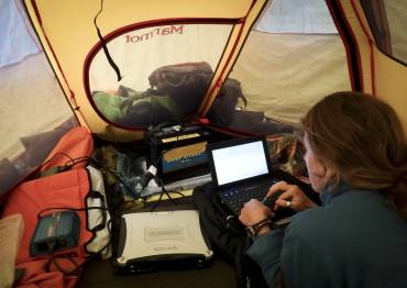 Lauren Oakes working in a tent