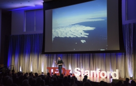 Dustin Schroeder speaks onstage at TEDxStanford