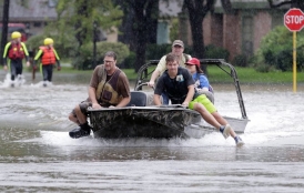 people use boat to navigate flooded streets