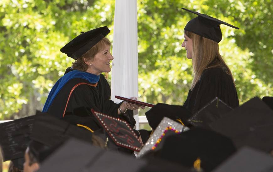 Pam Matson handing out a diploma